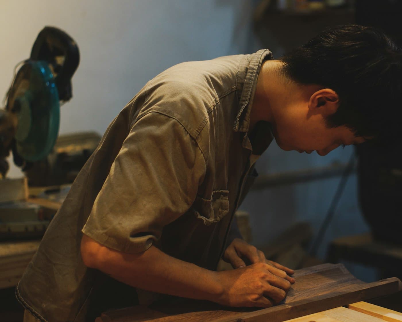 A carpenter working at a mitre saw on site