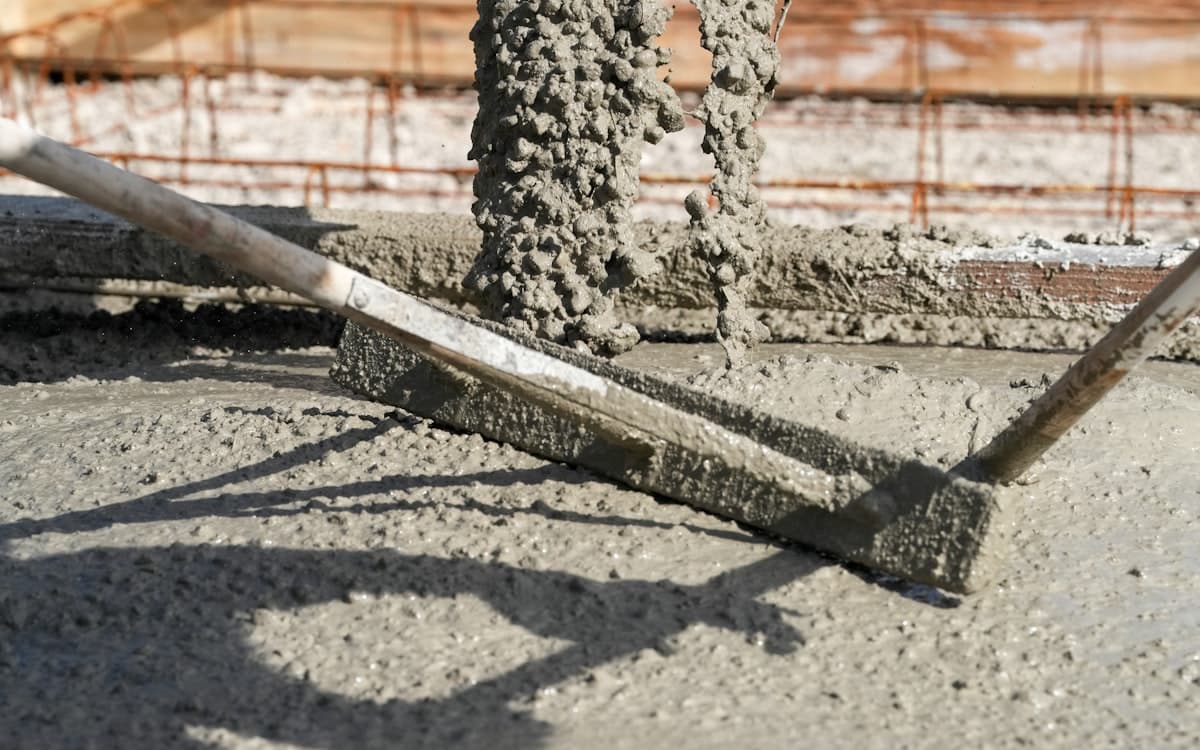 Fresh concrete being levelled with a screed