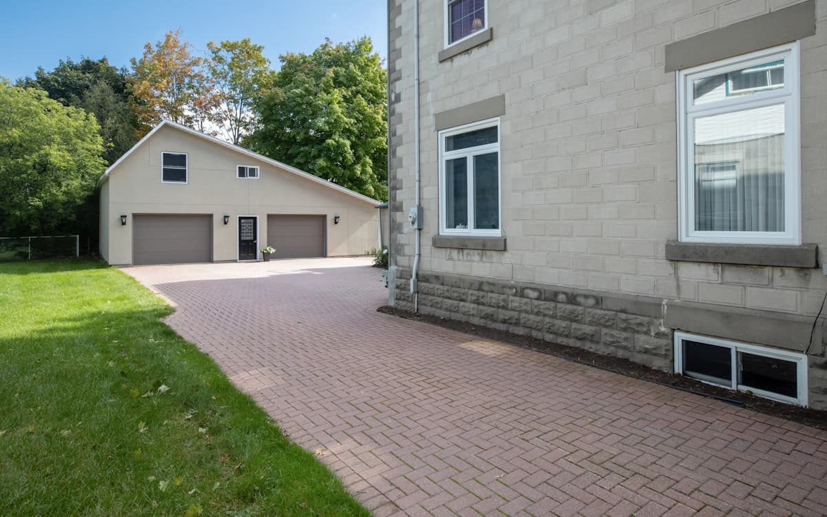 A paved driveway leading up to a two-storey house